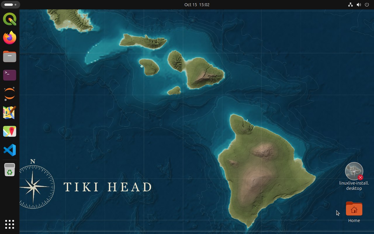 The Tiki Head desktop, with QGIS, Firefox, Files, Terminal, Jupyter, JOSM, Maps and Visual Studio Code in the dock over a nautical chart of Hawaii.